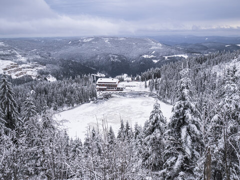View over the snow covered Mummelsee and Black Forest
