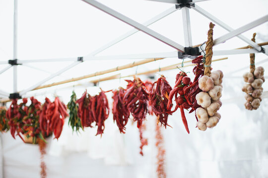 Italy: dried red chilli peppers and garlic for sale at the market