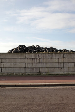 Pile of car tires behind a wall