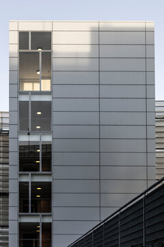 View from the outside of several floors of lifts in a commercial building