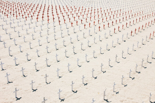 Memorial with crosses and religious symbols on a beach graveyard