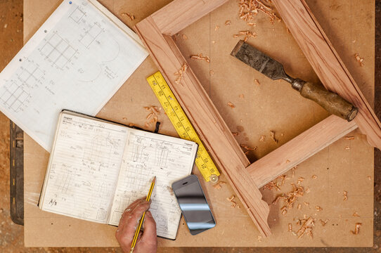 A tradesman measures and checks specifications