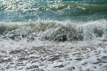 Surf of the sea wave at the seashore.