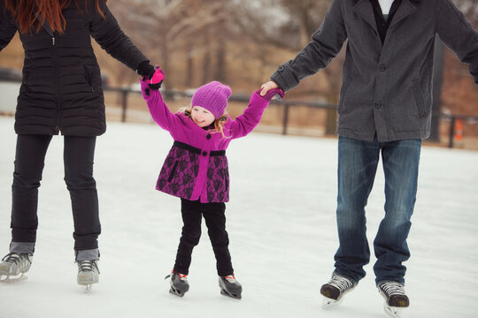 Skating: Little Girl Learning To Skate Gets Support From Parents