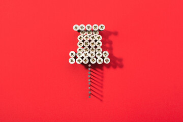 A pin shaped with lot of screws on red background. Social media icon.