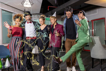 Business workers from different ethnicities celebrate a great achievement after long effort. Business people and members of LGBT work together and enjoy big success in a party