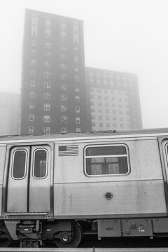New York City subway train against the backdrop of apartment buildings