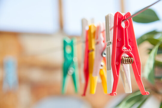 Colorful plastic clothespins on metal string