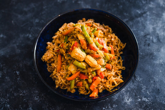 plant-based food, vegan ginger noodls with stir fried veggies in green curry sauce