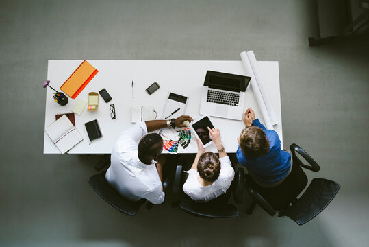 Young business people working - overhead