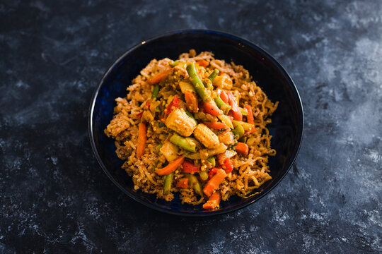 plant-based food, vegan ginger noodls with stir fried veggies in green curry sauce