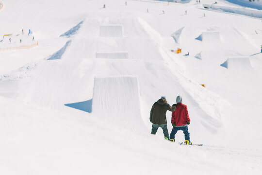 Two snowboarders on a ski slope.