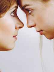 Two girls looking serious at each other.