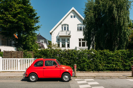Old car parked in front of house