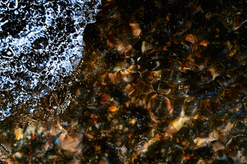 Foam on the water. Dark water.