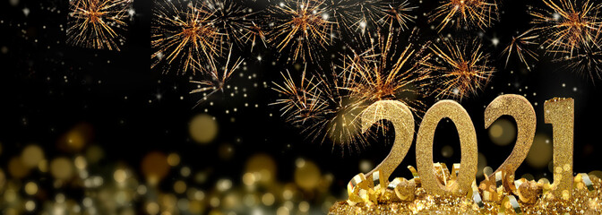 2021 golden figures standing glitters in firework in the night