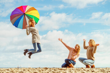 Women jumping with umbrella