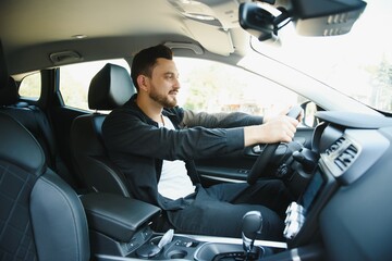 Fashion portrait of stylish young man in the car