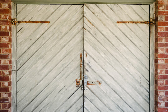 rustic timber plank door with diagonal lengths creating a chevron pattern