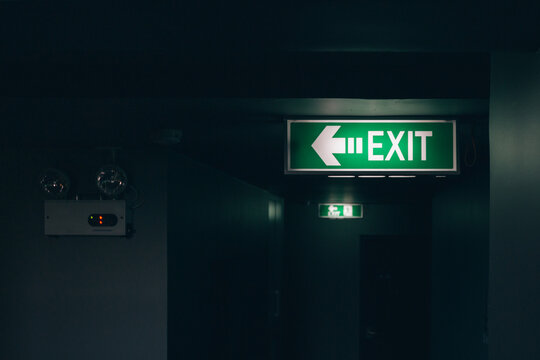 Glowing exit sign in a hallway