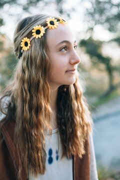 Teenage girl with wavy hair and a sunflower headband