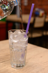 A glass of water on a blurred restaurant background