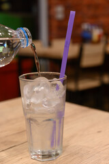A glass of water on a blurred restaurant background