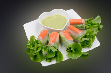 Crab stick salad rolls placed on a white plate