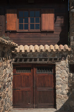Facade of old wooden and stone house