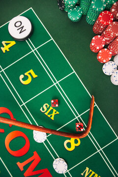 Casino: Dealer Uses Stick To Pull In Dice On Craps Table