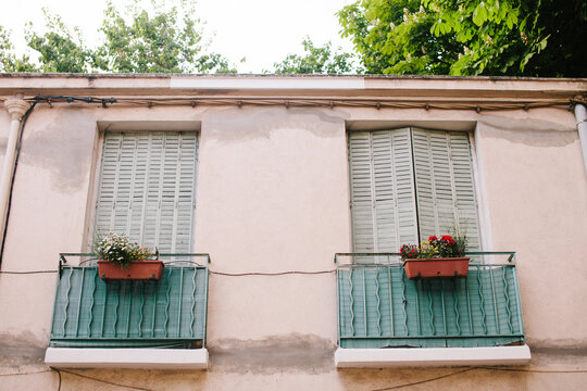 Two balconies with flower boxes