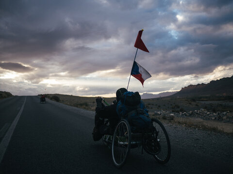 Handbiker approaching dark clouds