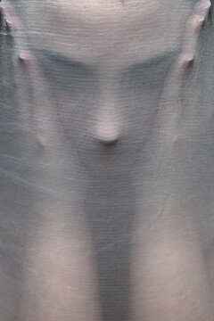 Close up of woman's face wrapped in a fabric cocoon