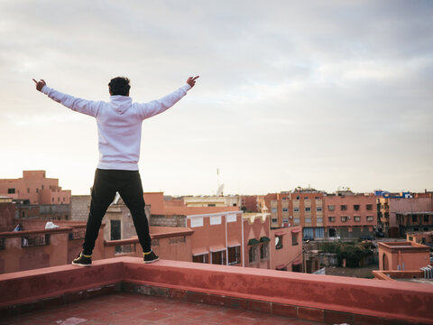 Arabic man on roof fucking the whole city with raised middle fingers