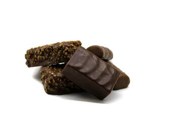 Chocolate sweets with bird's milk crushed hazelnuts and a bar