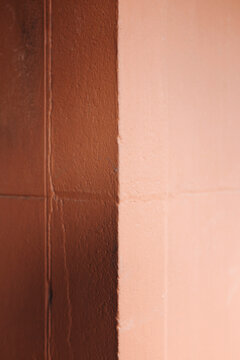 Painted wall casting shadow from cinder block wall