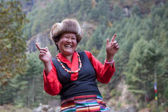 Sherpa woman wearing a ethnic attire from the himalayas laughing.