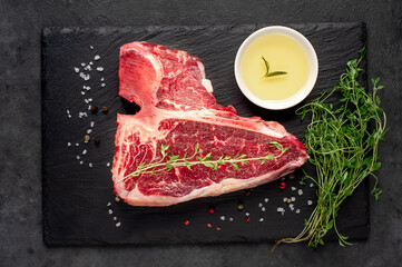 Obraz na płótnie Canvas raw t-bone steak with on stone background