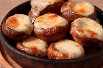 mushrooms baked with suluguni cheese on ketsi , a traditional Georgian dish , horizontal, no people 