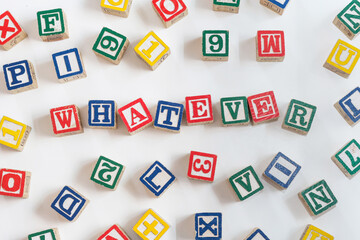 'Whatever' written in children's alphabet blocks
