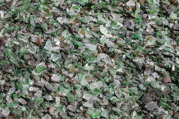 Details with shards of glass on a pile in a glass recycling facility.