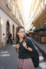 Obraz premium woman tourist walking on the street, summer fashion style, travel to Europe