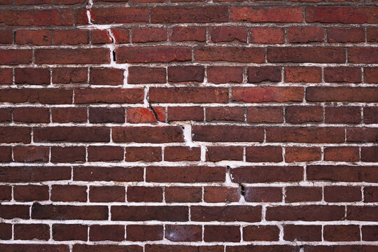 Fototapeta Old brick wall with a crack in the middle
