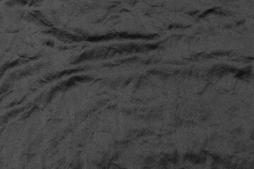 Abstract black fabric cloth texture background or liquid wave or wavy folds.