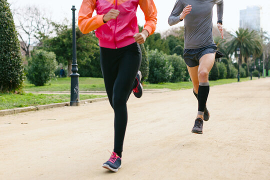 Closeup of a two friends running in the park.