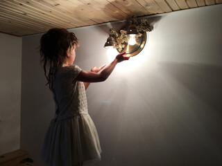 little girl in the twillight and light of a lantern