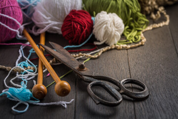 Variation of wool balls for knitting with old scissors in vintage style
