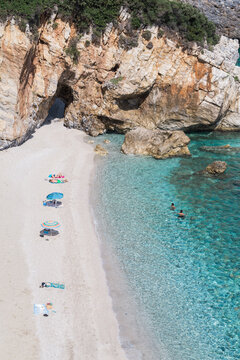 View of people relaxing on beach in Greece