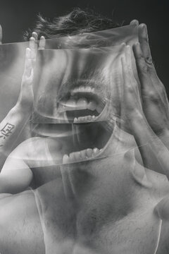scream, guy with tattoos and a magnifying glass screaming , double exposure