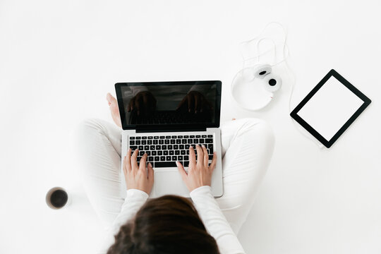 Overhead Shot Of Casual Woman With Laptop On White